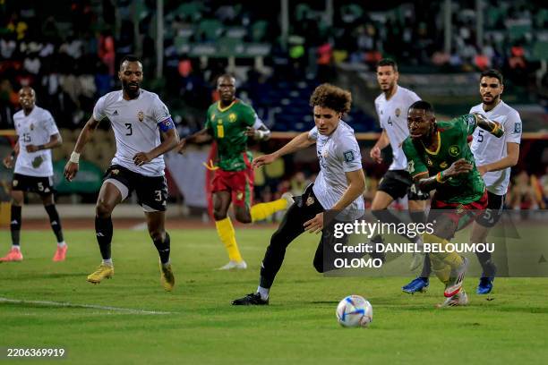 Cameroon's midfielder Martin Hongla fights for the ball with Libya's midfielder Osama Mukhtar Al Shremi during the FIFA World Cup 2026 Africa...