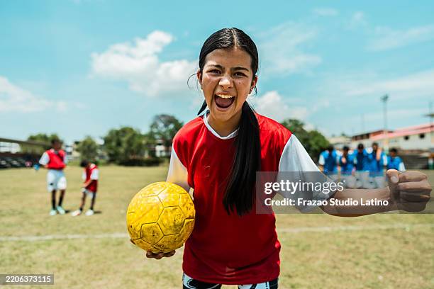 portrait of a female soccer player celebrating on the soccer field - scoring a goal stock pictures, royalty-free photos & images