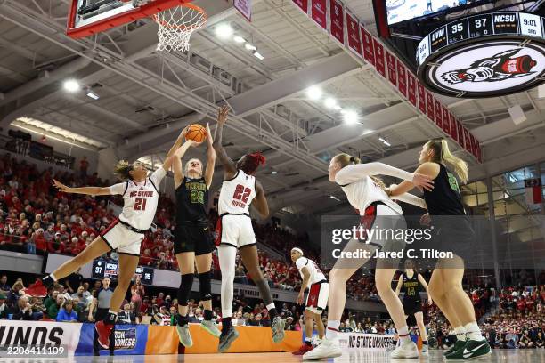 Nikola Priede of the Vermont Catamounts shoots the ball as Madison Hayes of the NC State Wolfpack defends in the first round of the NCAA Women's...