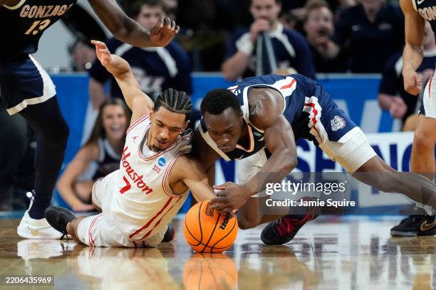 Milos Uzan of the Houston Cougars and Emmanuel Innocenti of the Gonzaga Bulldogs dive for the ball during the first half in the second round of the...