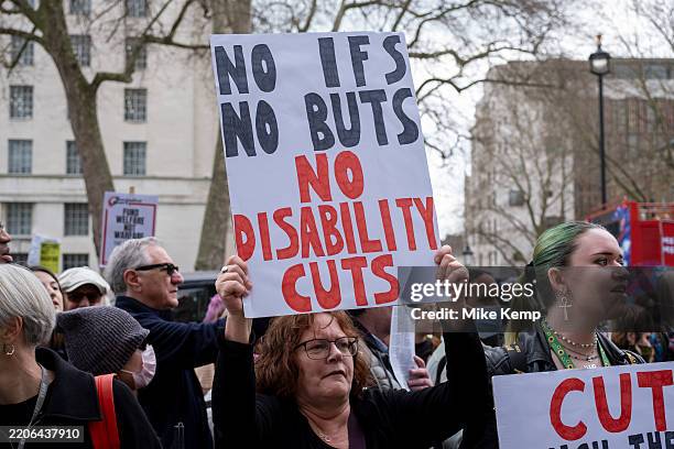 Protesters gather to demonstrate in Westminster against cuts to the welfare state and benefits and asking for the rich to be taxed as Chancellor...
