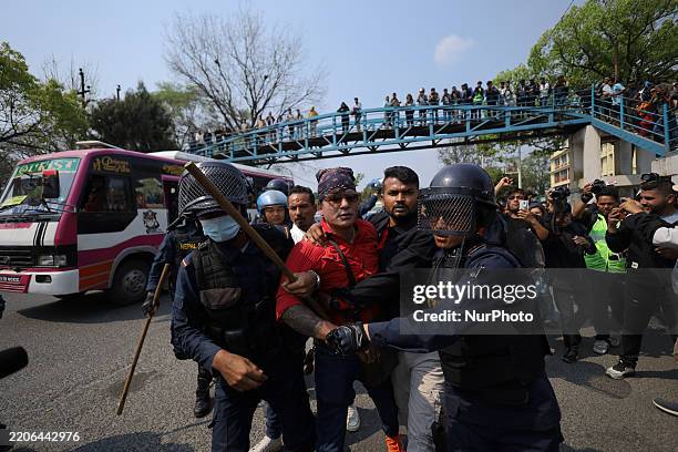 Nepal Police detains a demonstrator after a clash during a protest in front of the Nepal Electricity Authority office in Kathmandu, Nepal, on March...