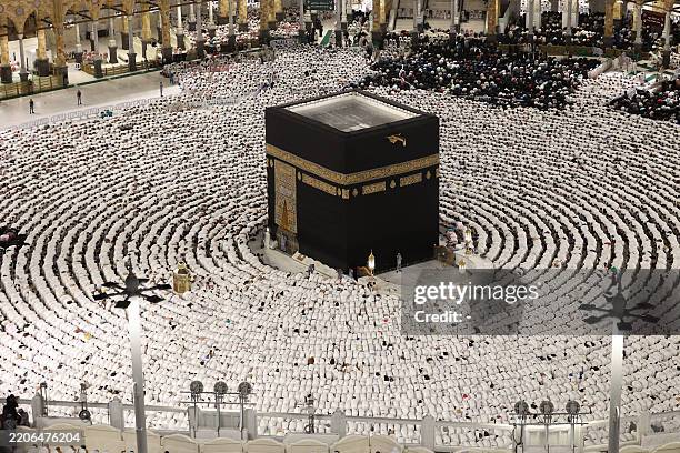 Muslims pray around the Kaaba at the Grand Mosque in the holy city of Mecca on Laylat al-Qadr or Night of Destiny, one of the holiest nights during...