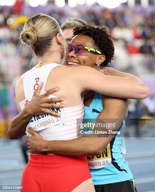 Gold medalist Devynne Charlton of Team Bahamas embraces fourth placed Pia Skrzyszowska of Team Poland after the Women's 60 Metres Hurdles final on...