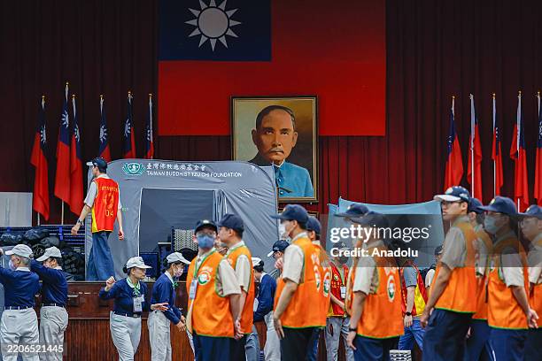 Volunteers and government personnel set up tents inside a high school during the civil defense drill, in Tainan, Southern Taiwan, on March 27, 2025....
