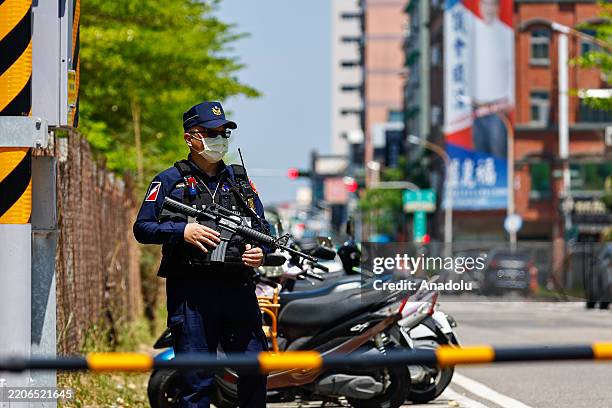 Police officers with heavy weapons stand guard during a civil defense drill, in Tainan, Southern Taiwan, on March 27, 2025. The exercise dubbed...