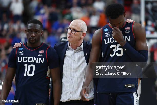 Head coach Dan Hurley of the Connecticut Huskies walks off the court with Hassan Diarra and Samson Johnson after losing to the Florida Gators 77-75...