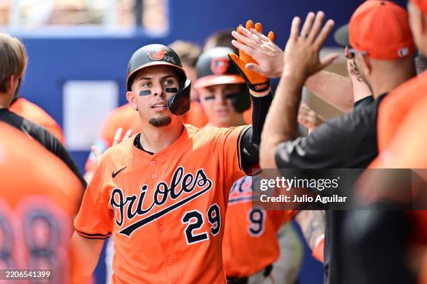 Ramón Urías of the Baltimore Orioles celebrates with teammates in the dugout after hitting a two-run home run in the second inning against the...
