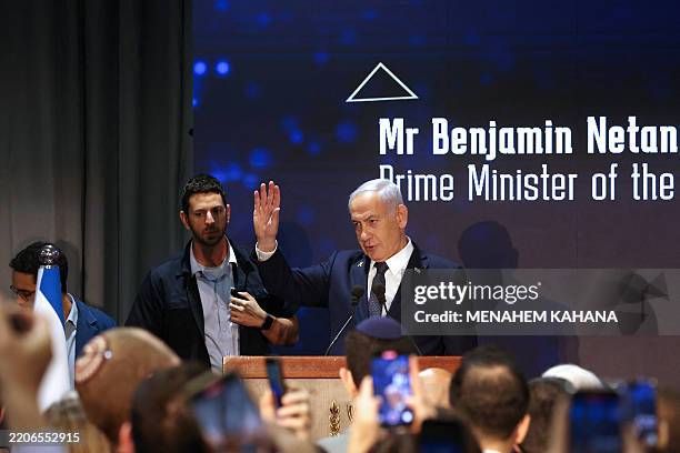 Israel's Prime Minister Benjamin Netanyahu waves before giving a speech during a conference on antisemitism in Jerusalem on March 27, 2025. Israel on...