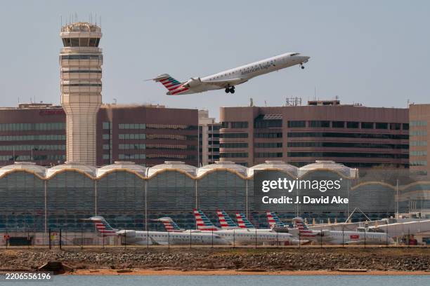 An American Eagle regional jet takes off over the American Airlines terminal at Washington Reagan National Airport on March 23, 2025 in Arlington, VA.