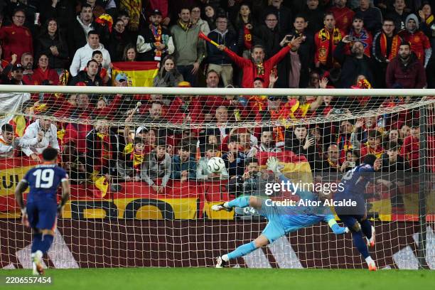 Unai Simon of Spain fails to save penalty from Memphis Depay of Netherlands during the UEFA Nations League Quarterfinal Leg Two match between Spain...