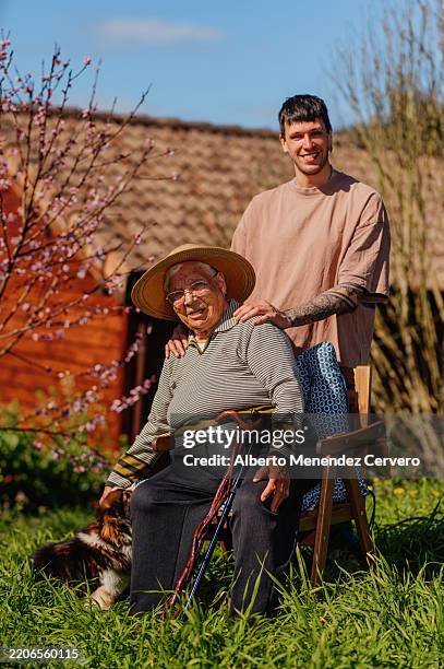 centenarian grandmother with grandson enjoying sunny day in garden - guy 109 stock pictures, royalty-free photos & images