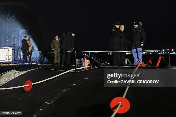 In this pool photograph distributed by the Russian state agency Sputnik, Russia's President Vladimir Putin visits the Russian nuclear-powered...