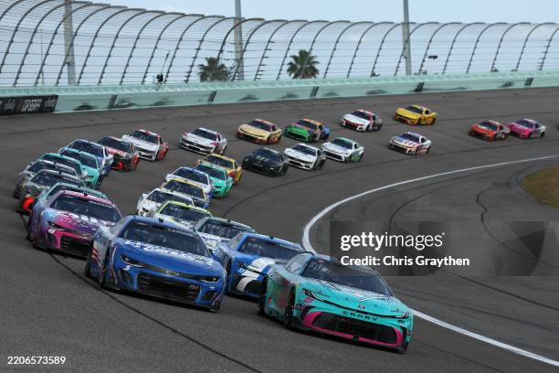 Kyle Larson, driver of the HendrickCars.com Chevrolet, and Bubba Wallace, driver of the Columbia Sportswear Company Toyota, race during the NASCAR...