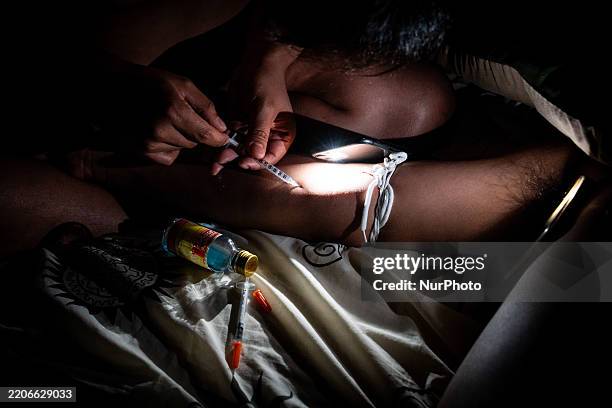 Someone injects methamphetamine, also called Ice or Crystal Meth, into someone else's arm during a chemsex encounter in Bangkok, Thailand, on March...