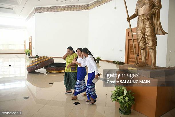 Women react as they walk in the National Museum in Naypyidaw on March 28 after an earthquake in central Myanmar. A powerful earthquake rocked central...