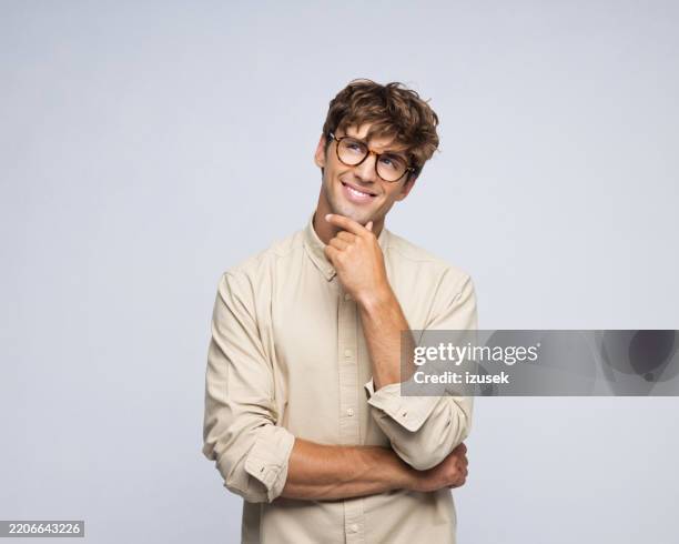 portrait of handsome young man - hand on chin stock pictures, royalty-free photos & images