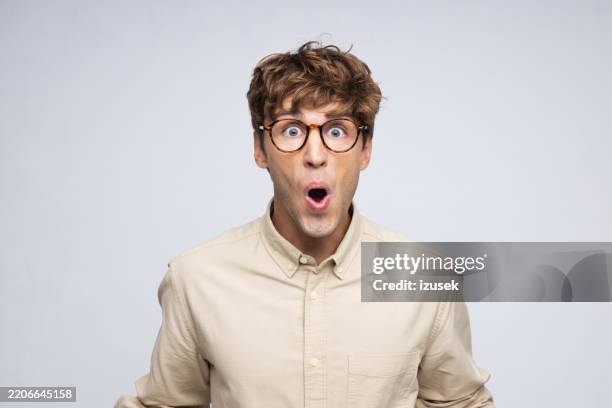 studio portrait of handsome young caucasian male - överraskning bildbanksfoton och bilder