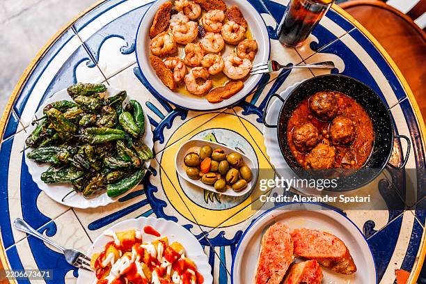 variety of colourful spanish tapas served at a restaurant, high angle view - mittelmeerküche stock-fotos und bilder