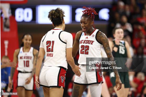Saniya Rivers of the NC State Wolfpack celebrates with Madison Hayes in the second half while playing the Michigan State Spartans in the second round...