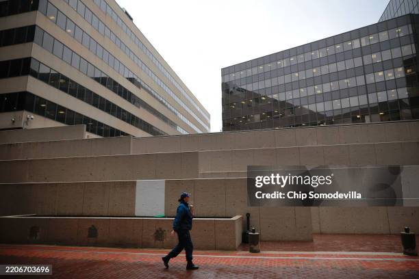 An employee of the Federal Emergency Management Agency walks into the government organization's headquarters in Southwest Federal Center on March 24,...
