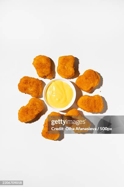 overhead view of crispy chicken nuggets and cheese dip fast food - eating chicken nuggets stock pictures, royalty-free photos & images
