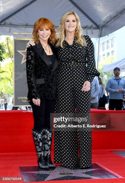 Reba McEntire and Trisha Yearwood pose onstage during the ceremony honoring Trisha Yearwood with a Star on the Hollywood Walk of Fame on March 24,...