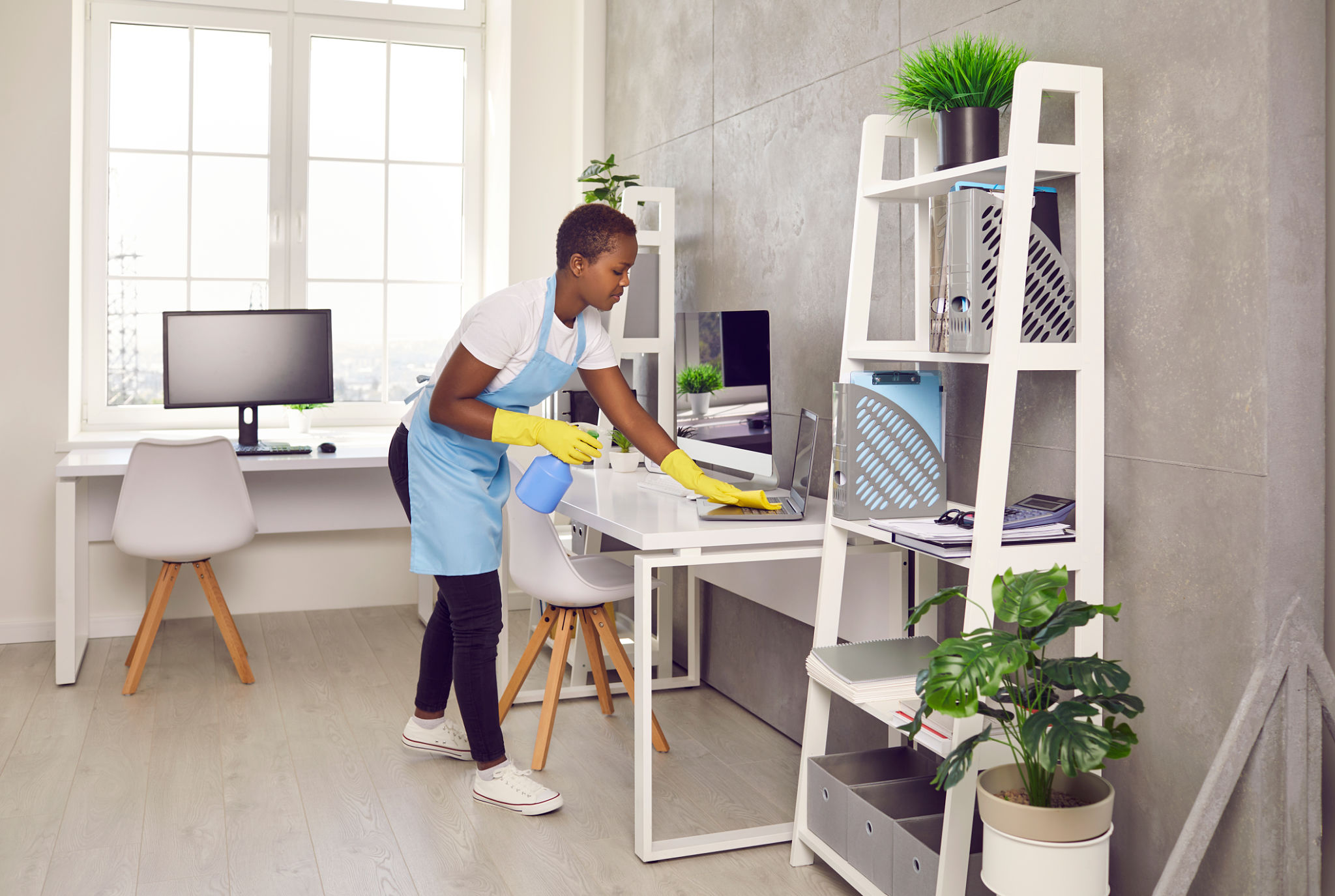 African American woman housekeeper clean office room African American woman housekeeper clean office room