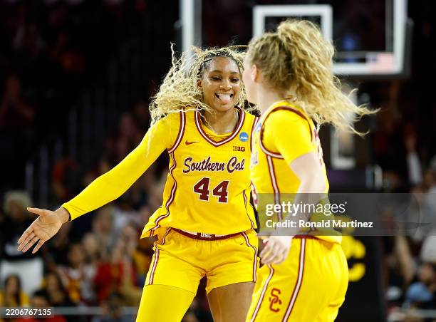Avery Howell of the USC Trojans celebrates a three-point shot with Kiki Iriafen against the Mississippi State Bulldogs in the first half during the...