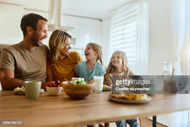 cheerful family talking during breakfast in dining room. - breakfast table stock pictures, royalty-free photos & images