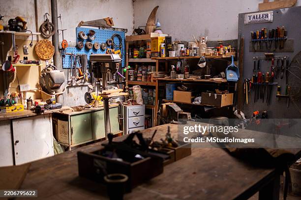 organized woodworking workshop with tools, supplies, and workbench in a rustic setting - workbench stock pictures, royalty-free photos & images