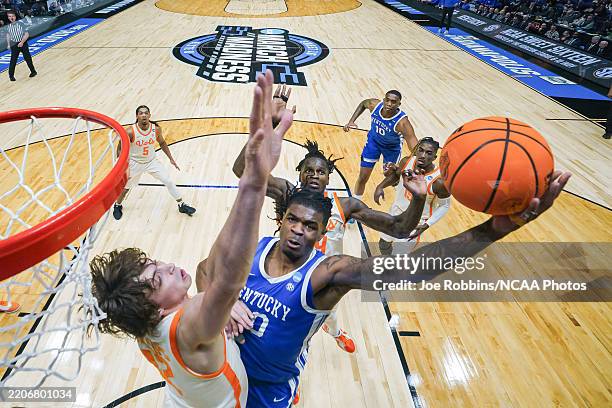 Otega Oweh of the Kentucky Wildcats shoots the ball against Cade Phillips of the Tennessee Volunteers in the Sweet Sixteen round of the 2025 NCAA...