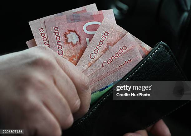 Person holds Canadian dollar banknotes, in Edmonton, Alberta, Canada, on March 26, 2025.