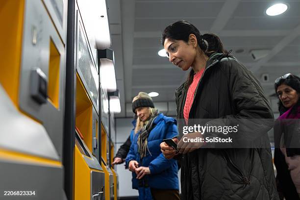 purchasing train ticket from machine - train ticket machine stock pictures, royalty-free photos & images