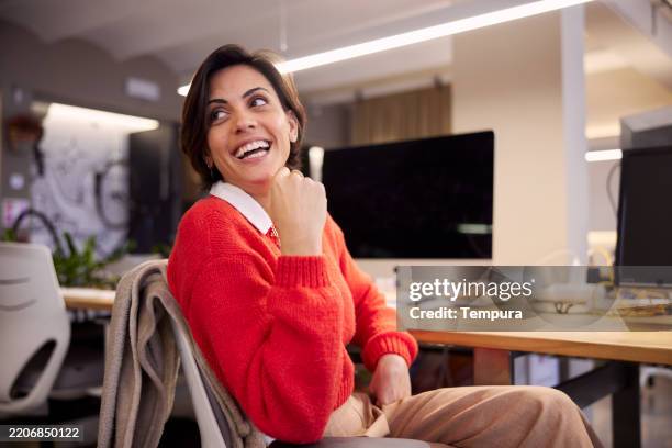an office worker steps away from his computer to chat with another worker. - over shoulder computer stock pictures, royalty-free photos & images