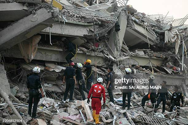 Rescuers search for survivors trapped in the collapsed Sky Villa Condominium building in Mandalay on March 29 a day after an earthquake struck...
