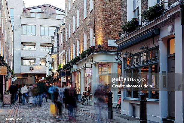 crowded shopping street in london west end - high street stock-fotos und bilder