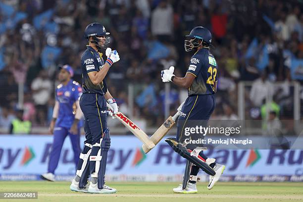 Shubman Gill of Gujrat Titans and Sai Sudharsan of Gujrat Titans interact during the 2025 IPL match between Gujarat Titans and Mumbai Indians at...