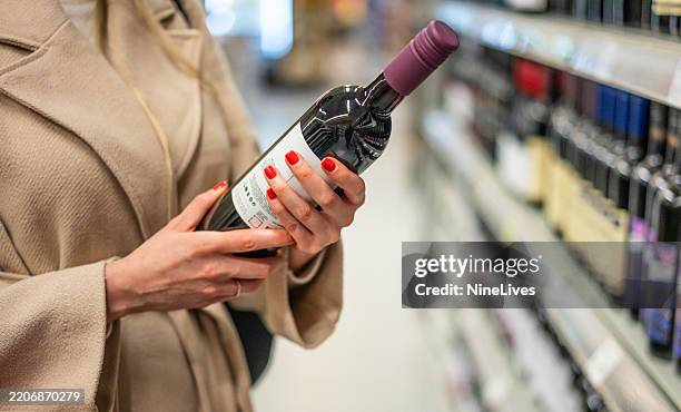 mujer, compra vino en el supermercado - licores de alta graduación fotografías e imágenes de stock