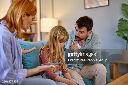 Parents arguing with daughter about excessive smartphone use at home Parents arguing with daughter about excessive smartphone use at home