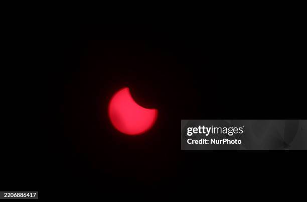 Partial solar eclipse occurs behind the clouds in Linkoping, Sweden, on March 29, 2025.