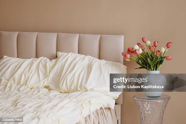 cozy bedroom scene with tulips in vase - fresh from bed stock pictures, royalty-free photos & images