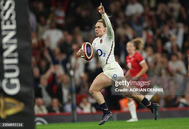 England's centre Megan Jones runs in their second try during the Women's Six Nations international rugby union match between Wales and England at the...