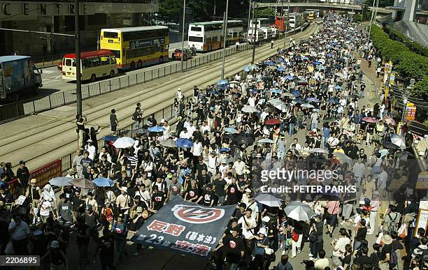 People participate in a huge protest march against a controversial anti-subversion law known as Article 23 in Hong Kong 01 July 2003. Tens of...