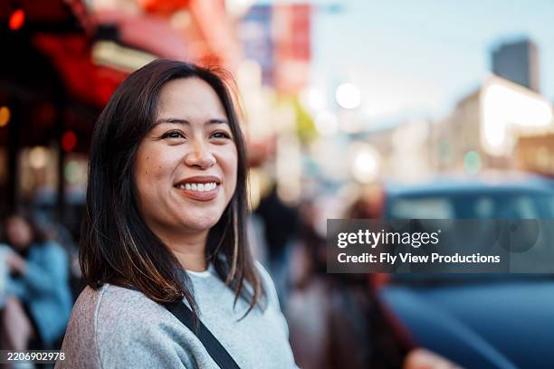smiling woman on city street in little italy, san francisco, california - pacific islanders stock pictures, royalty-free photos & images