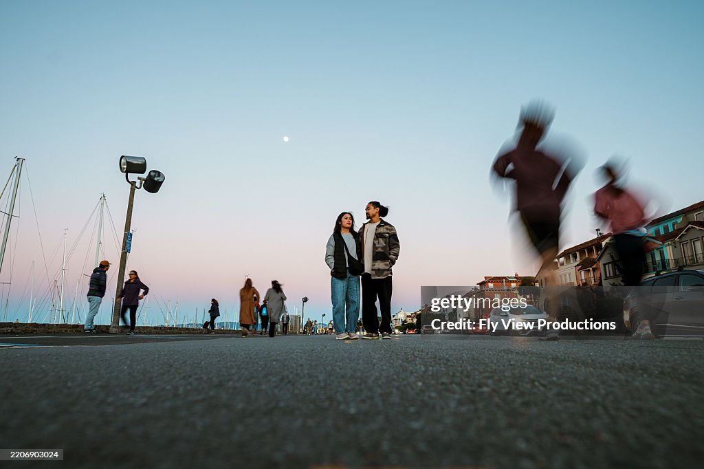 Loving couple on a walk at sunset along San Francisco Bay pedestrian path