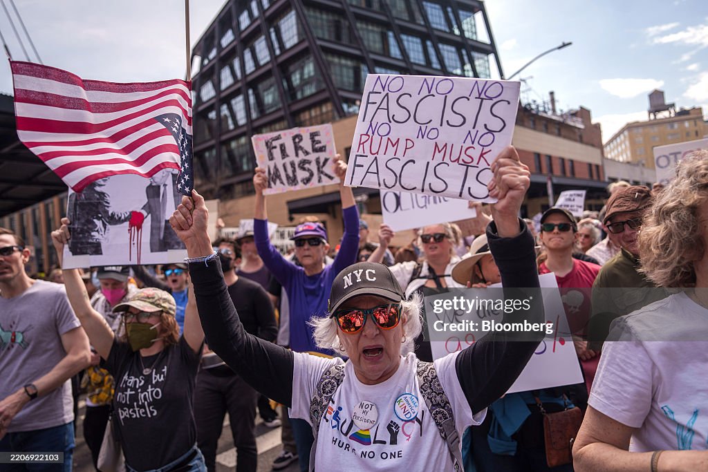 Protesters during a Tesla Takedown rally outside a Tesla showroom in