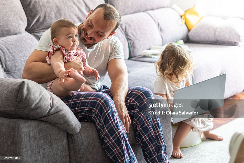Dad is holding his baby