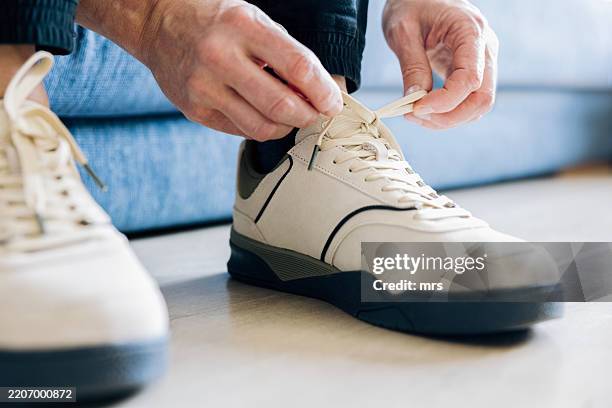 man tying shoelaces - tying shoelace stock pictures, royalty-free photos & images