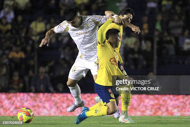 Tigres' Argentine midfielder Juan Brunetta and America's midfielder Erick Sanchez fight for the ball during the Liga MX Clausura football match...